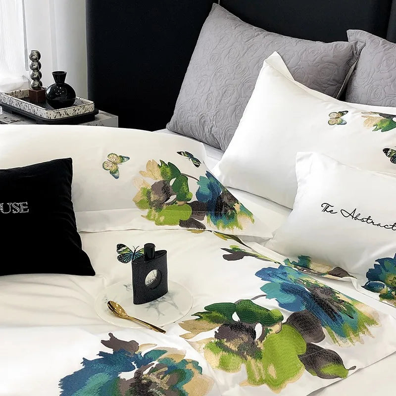 800TC Egyptian Cotton Floral-patterned bedding with decorative pillows and a black pillow on a bed. 
