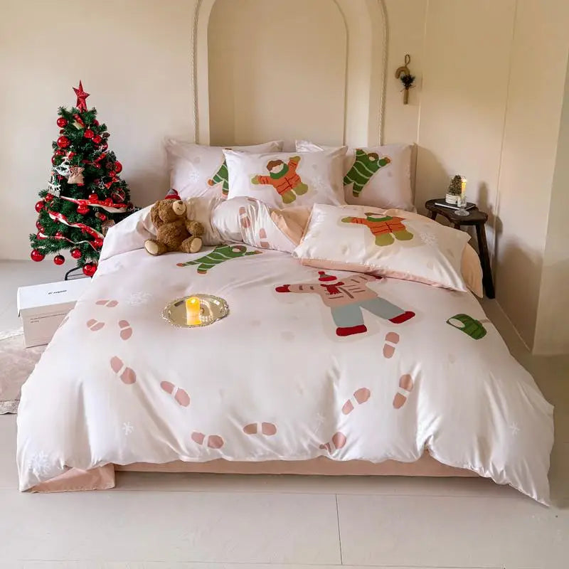 Bed with Christmas-themed bedding and a small Christmas tree in the corner.