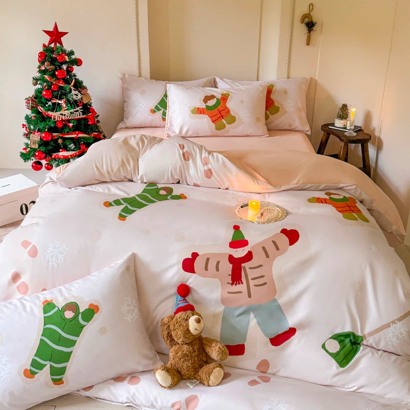 Bed with Christmas-themed bedding and decorations, including a small tree and teddy bear.