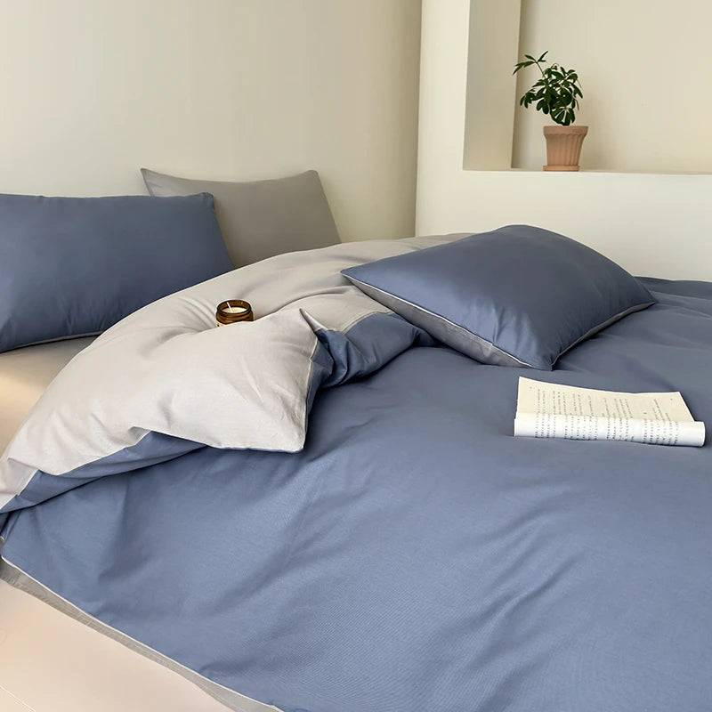 Bed with blue bedding and pillows in a bedroom setting