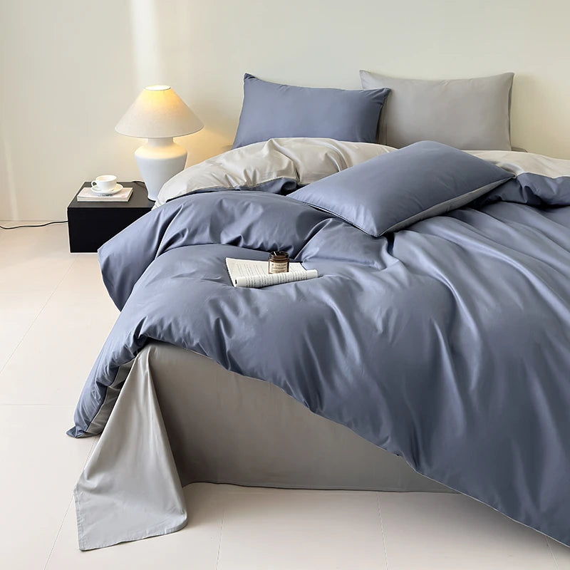 Bed with blue bedding and pillows in a minimalistic room.