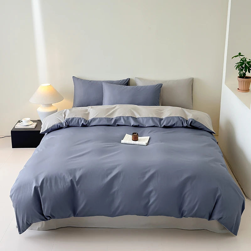 Bed with blue bedding in a minimalistic bedroom setting