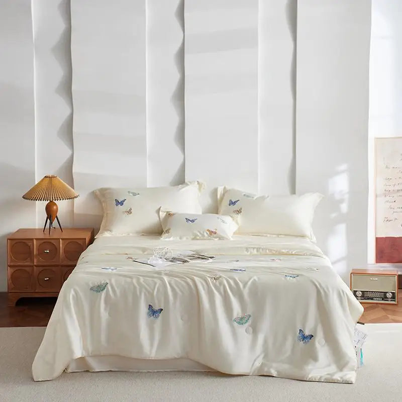 Bed with butterfly-patterned bedding in a minimalistic bedroom setting