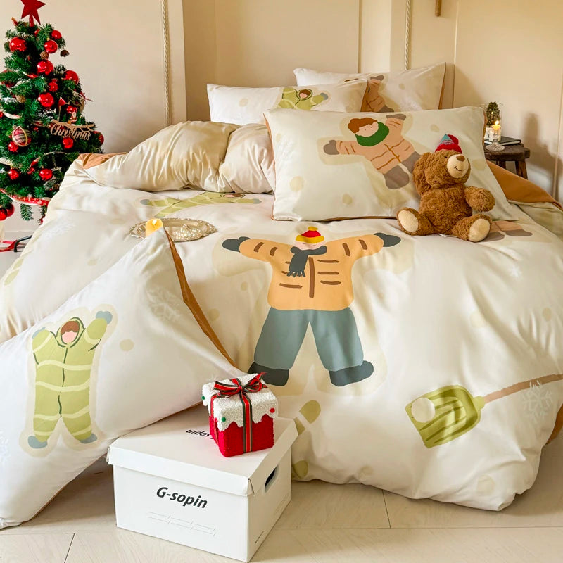 Bed with cartoon bedding featuring children in pajamas, a teddy bear, and a Christmas tree in the background.