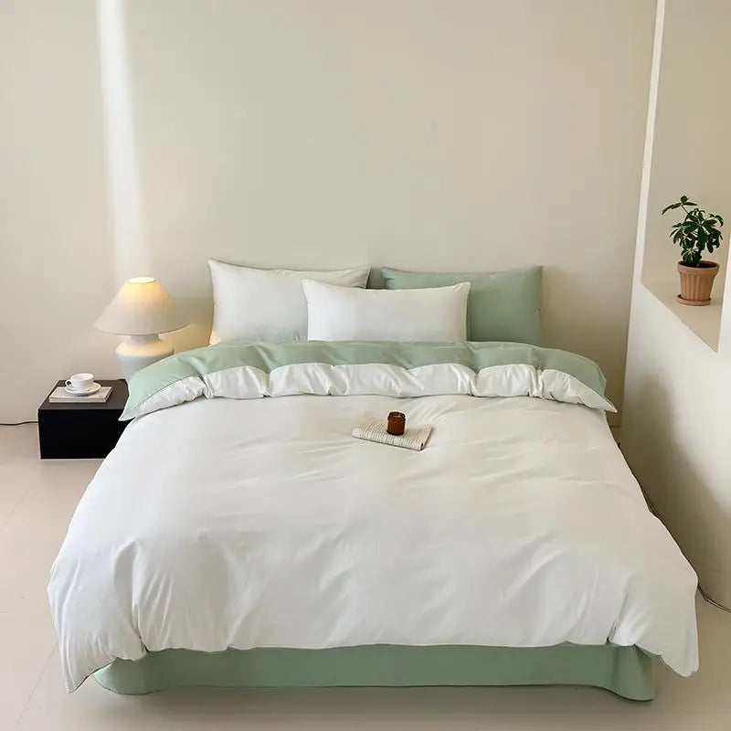 Bed with green and white bedding in a minimalistic bedroom setting.