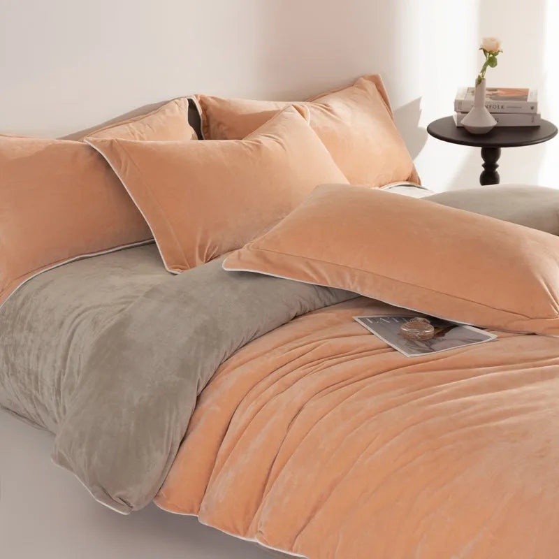 Bed with peach-colored comforter and pillows in a bedroom setting.