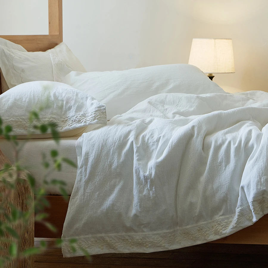 Bed with white bedding in a softly lit bedroom