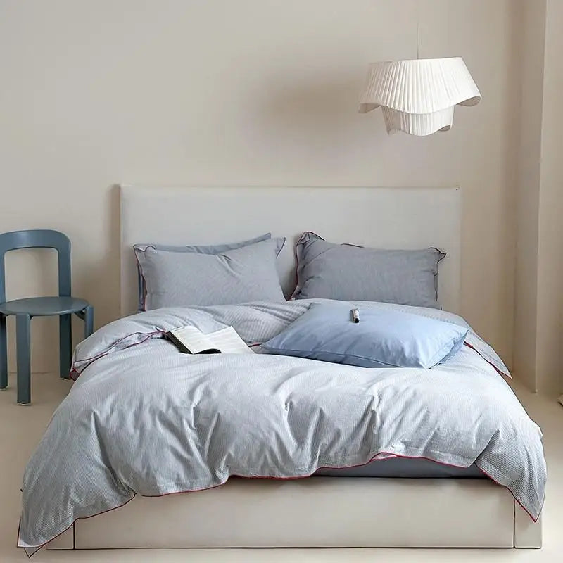 Bedroom with a bed featuring light gray bedding and pillows