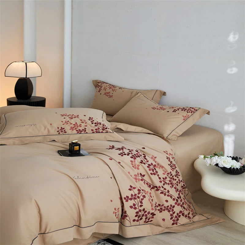 Beige bedding set with floral patterns on a bed by The Happy Ladies