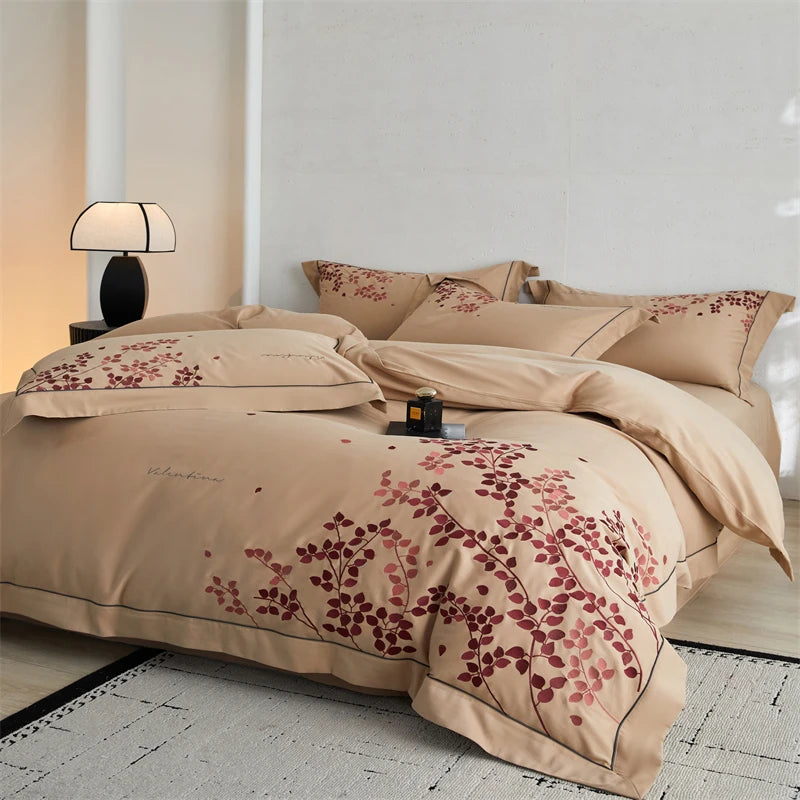 Beige bedding set with floral patterns on a bed in a bedroom.