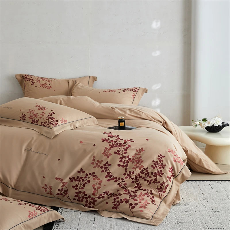 Beige bedding set with floral patterns on a bed in a room.