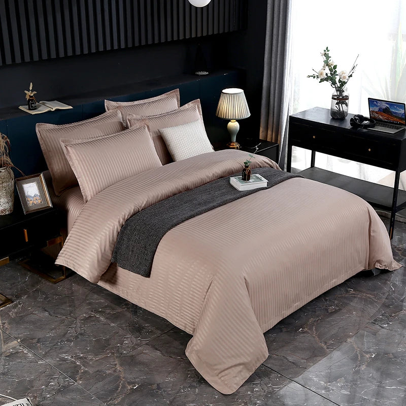 Beige bedspread set on a bed in a bedroom with decor elements.