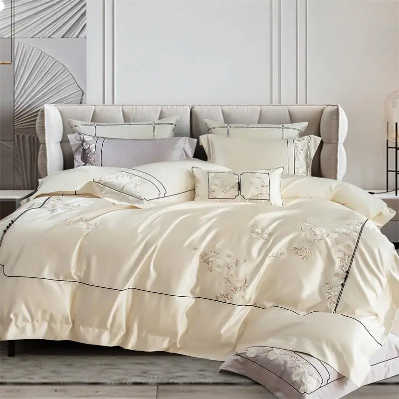 Beige bedspread with embroidery on a bed in a stylish bedroom.