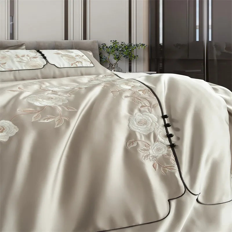 Beige embroidered bedding set on a bed duvet cover set.