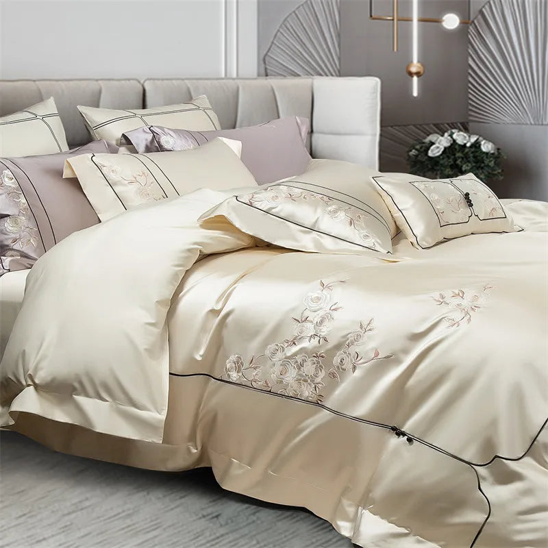 Beige embroidered bedding set on a bed in a bedroom setting