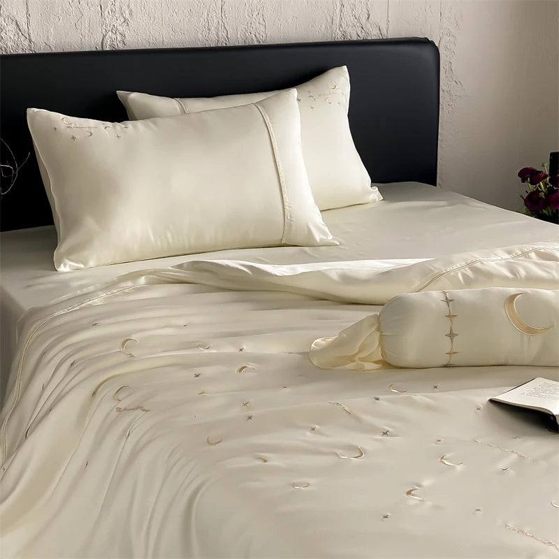 Beige lyocell bedding set on a bed with a black headboard.