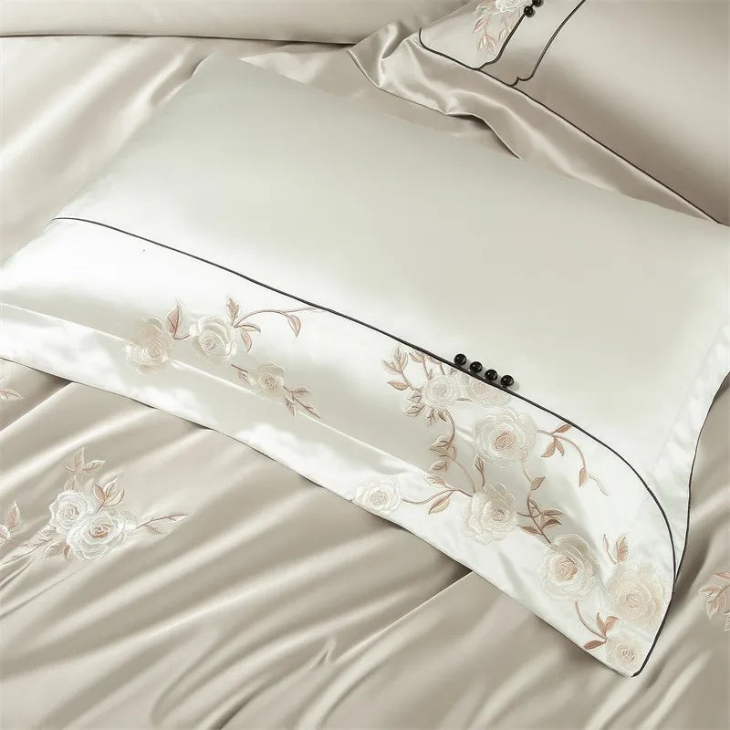 Beige pillowcases with floral embroidery on a matching fabric background