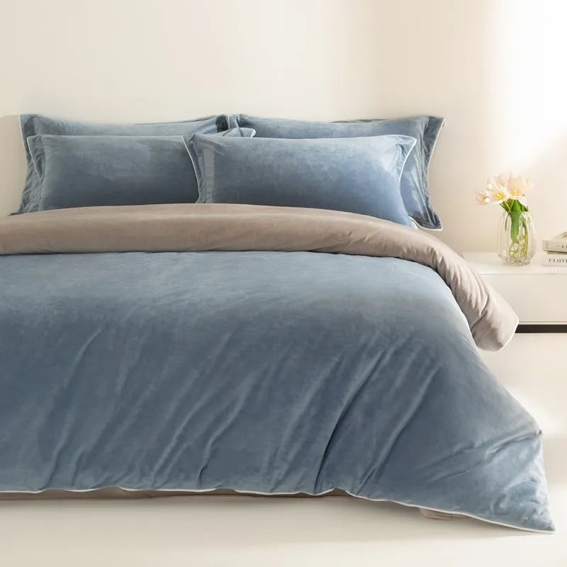 Blue bedding set with pillows on a bed in a bedroom setting