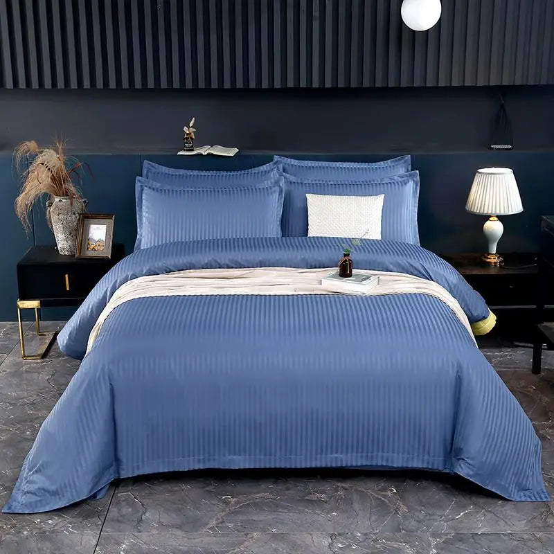 Blue striped bedding set on a bed in a bedroom.