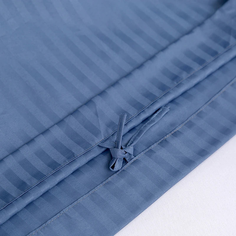 Blue striped bedding set with a close-up of the texture on a white background