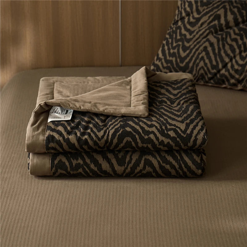 Brown stripes quilted neatly folded blanket 