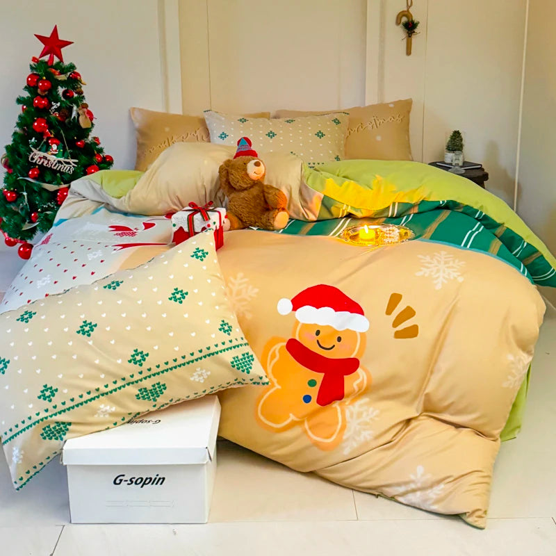 Christmas-themed bedding set with gingerbread design on a bed, featuring a small tree and teddy bear.