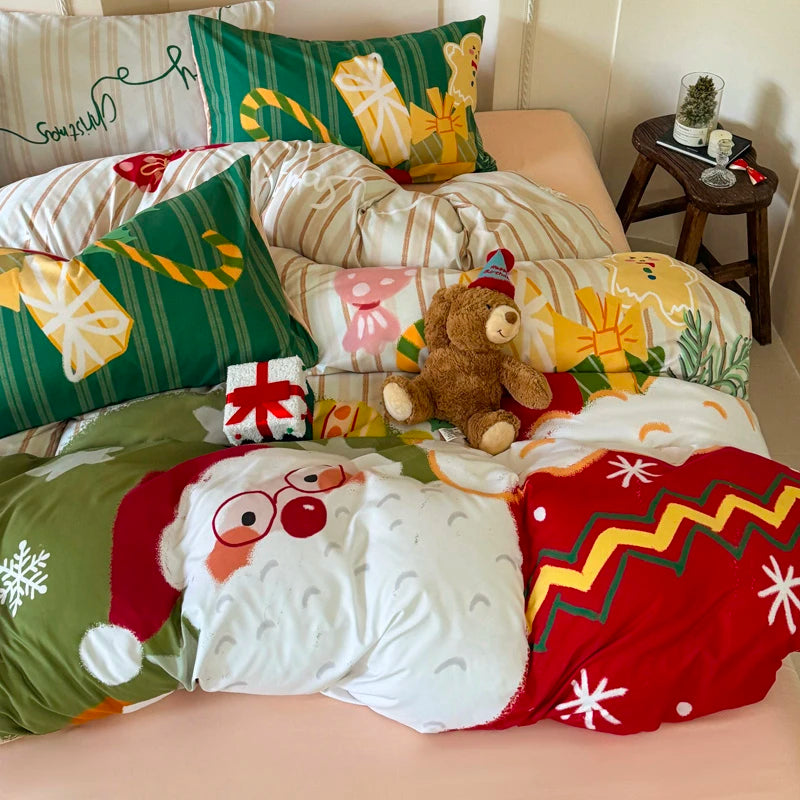 Christmas-themed bedding set with pillows and a teddy bear on a bed.