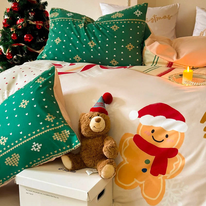 Christmas-themed bedding set with teddy bear and gingerbread man design on a bed.