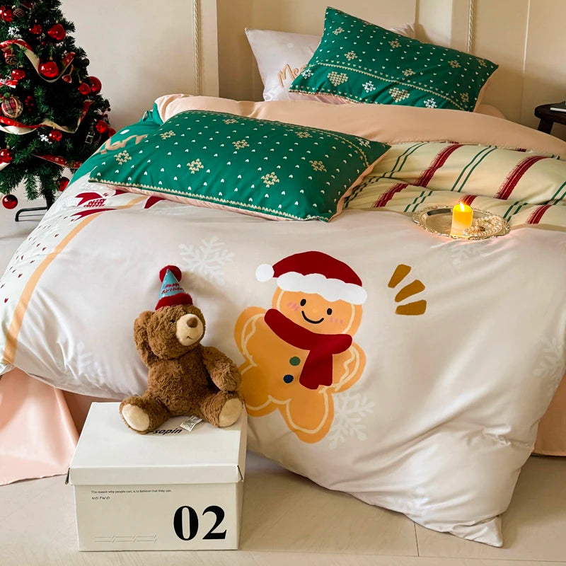 Christmas-themed bedding set with teddy bear and gingerbread man on a bed.