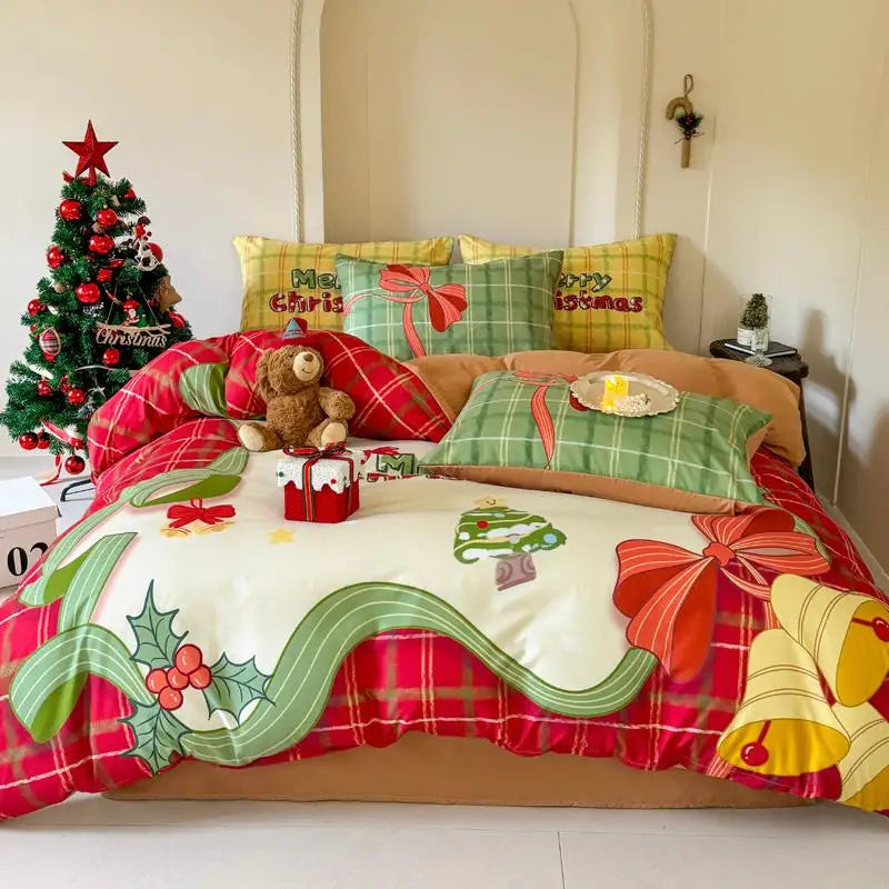 Christmas-themed bedspread with decorative pillows and a small tree in a bedroom setting.