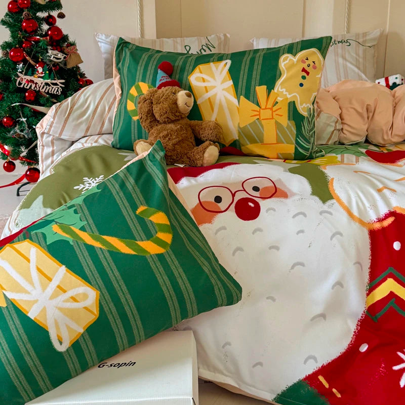 Christmas-themed pillows and blanket with festive designs on a bed.