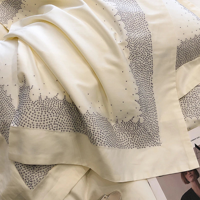 Close-up of a beige fabric for bedding set with black bead detailing