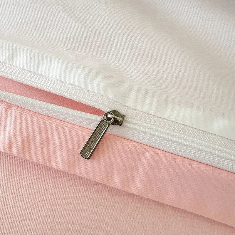 Close-up of a white zipper with pink fabric on a white background