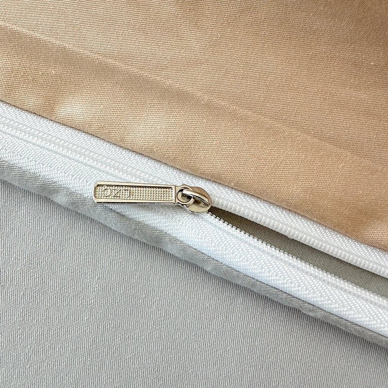 Close-up of a zipper on a beige and gray fabric background