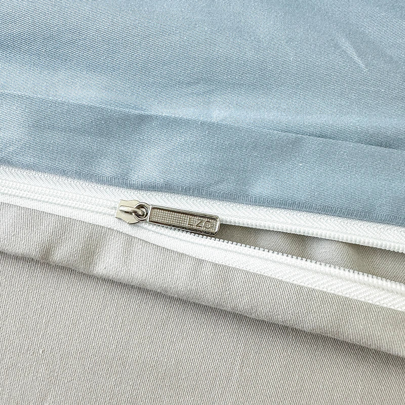 Close-up of a zipper on a light blue and gray fabric background