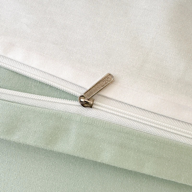 Close-up of a zipper on a light green and white fabric