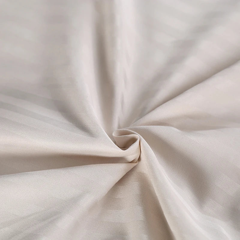 Close-up of beige bedding set with folds
