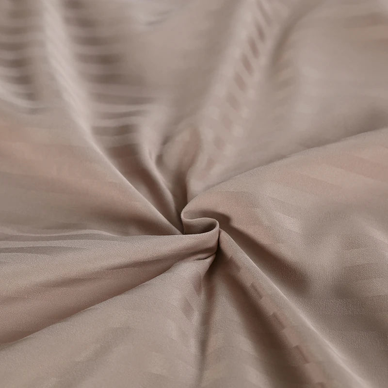 Close-up of beige bedding with a subtle pattern