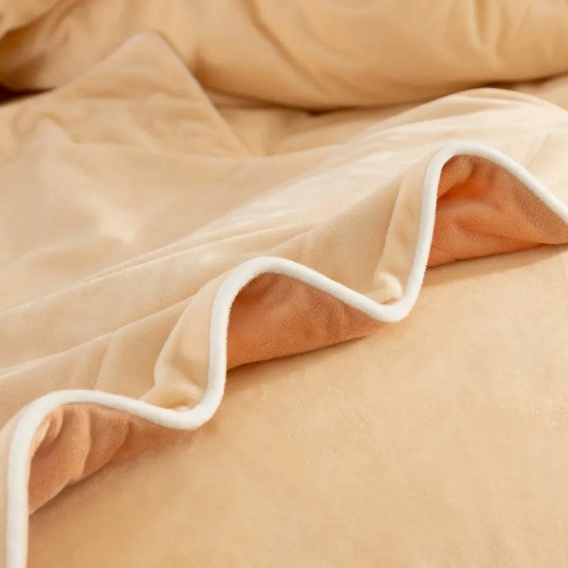 Close-up of beige comforter with white trim on a bed
