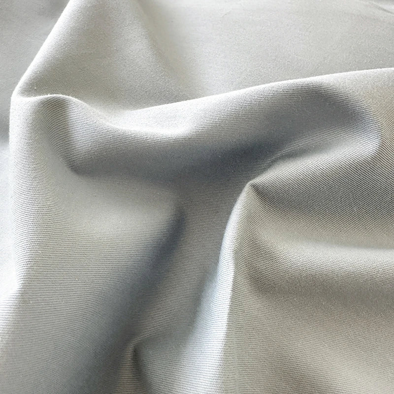 Close-up of light gray fabric with folds