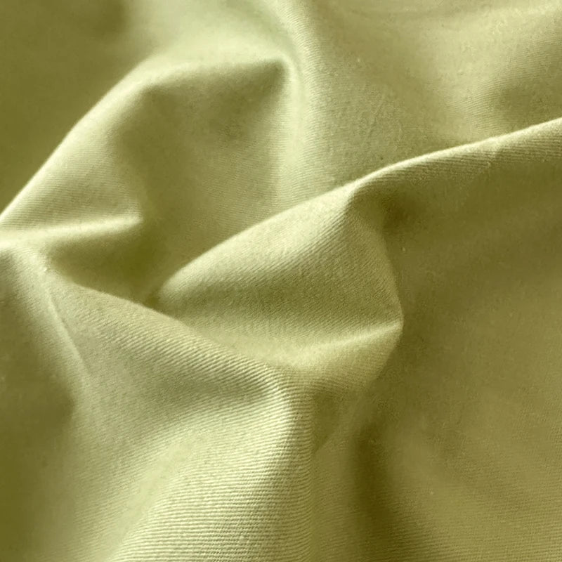 Close-up of light green fabric with folds