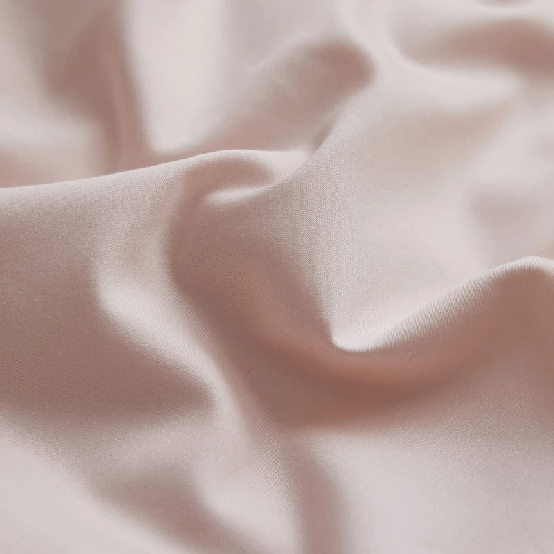 Close-up of light pink fabric with soft folds
