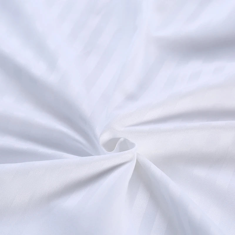 Close-up of white bedding set with a subtle texture