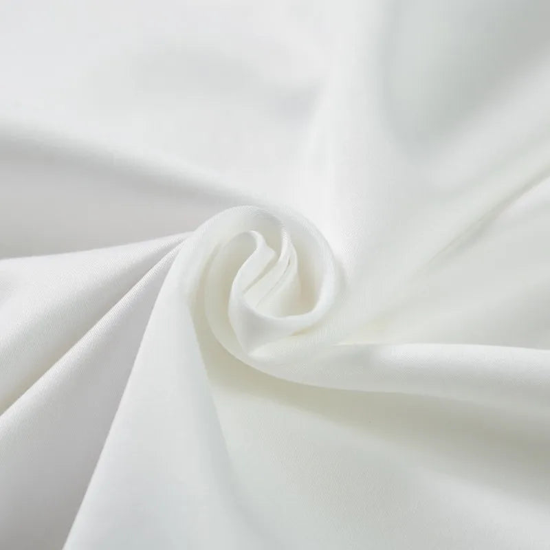 Close-up of white fabric with folds the happy ladies bedding set collection