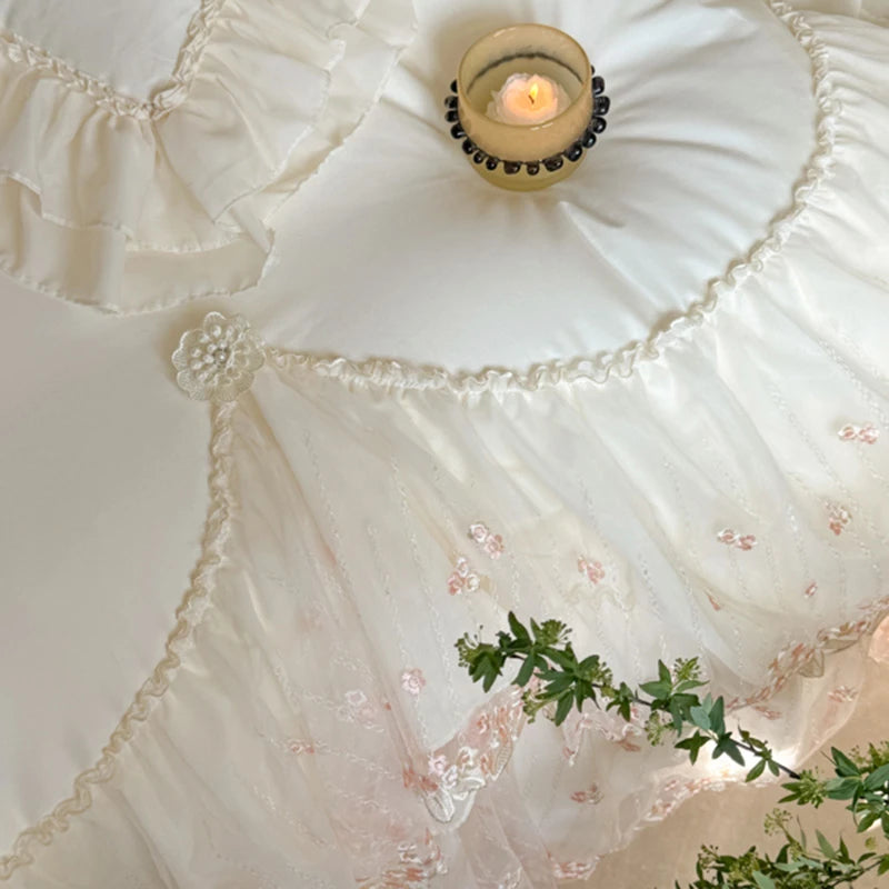 Decorative white pillow with lace details and a small candle on top