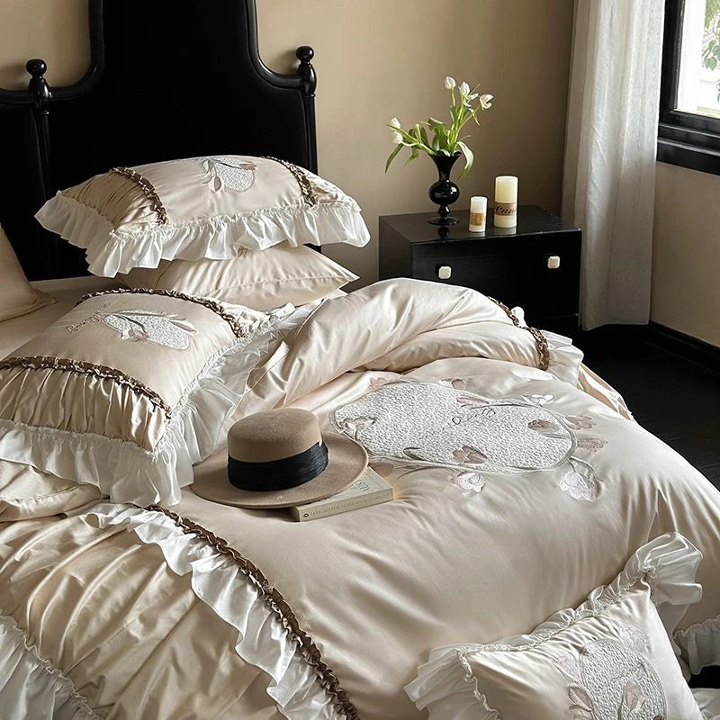 Delicate white bedding with lace details on a bed in a bedroom setting.