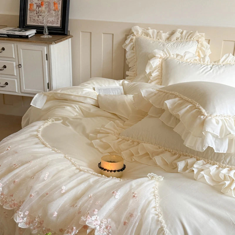 Delicate white ruffled bedding set in a bedroom setting.