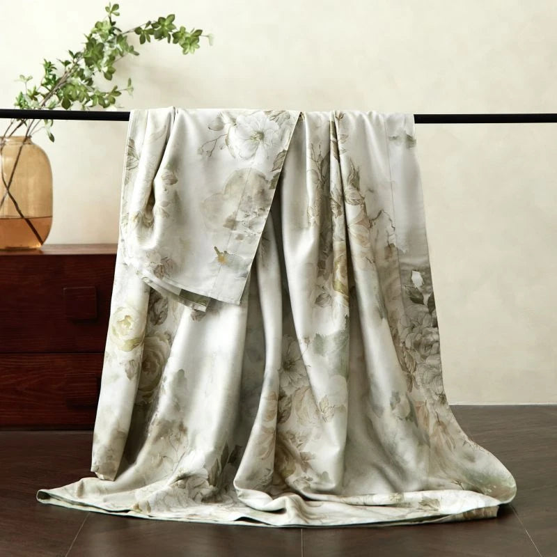 Floral patterned bed sheet draped over a surface with a neutral background