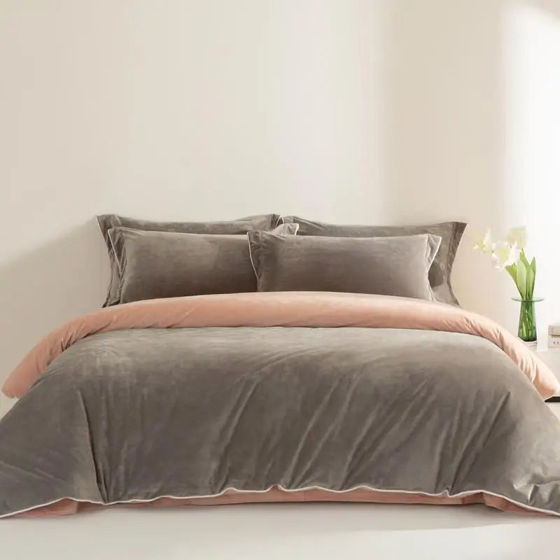 Gray and peach bedding set on a bed with a light background
