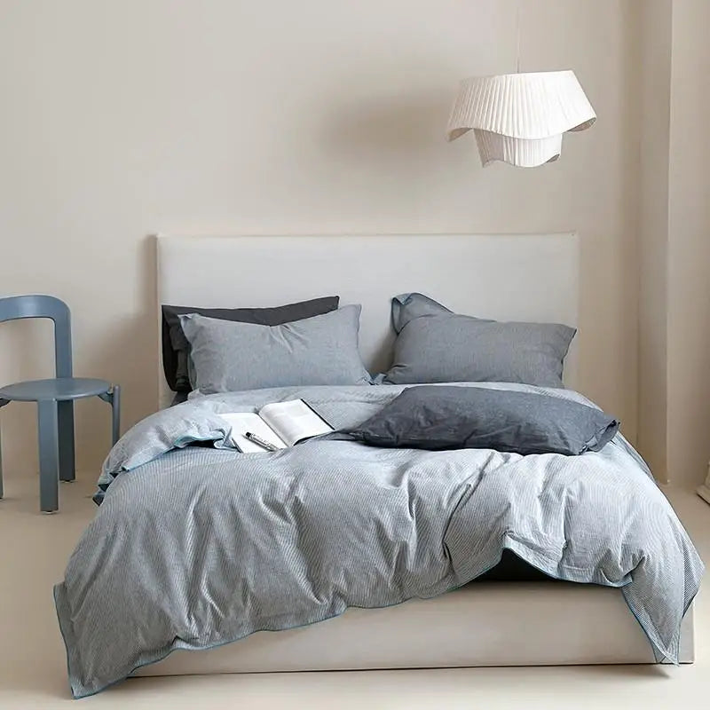Gray bedding set on a bed in a minimalistic room